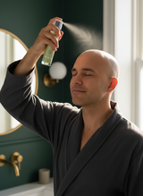 Person misting Good Bald after-shave spray onto scalp